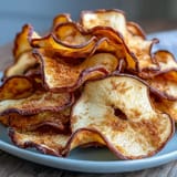 Sweet and crunchy apple chips sprinkled with cinnamon sugar, made effortlessly in the air fryer for a guilt-free treat.