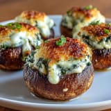 Air-fried stuffed mushrooms filled with rich cream cheese, spinach, and Parmesan for a savory appetizer.  