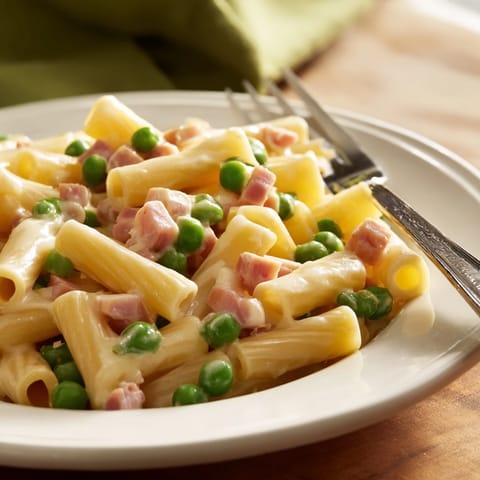 Hearty Spring Pea & Ham Pasta tossed in a velvety Parmesan cream sauce, perfect for a cozy family dinner.