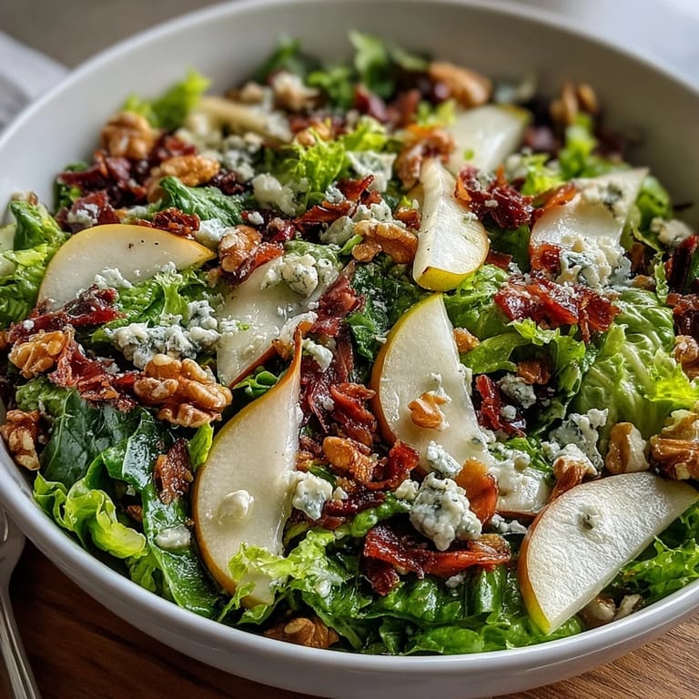 A vibrant Frisée Pear Blue Cheese Bowl with toasted walnuts and zesty vinaigrette, ready for a light lunch or dinner.  
