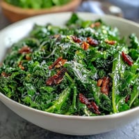 A vibrant arugula salad drizzled with bright lemon vinaigrette and topped with delicate Parmesan shavings, ideal for a light lunch or dinner starter.