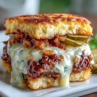 Golden-brown Memorial Day BBQ smash burger sliders piled high with toppings.